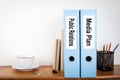 Public Relations and Media Plan binders in the office. Stationery on a wooden shelf Royalty Free Stock Photo