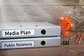 Public Relations and Media Plan - two folders on wooden office desk Royalty Free Stock Photo