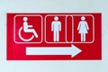 Public restroom signs with a disabled access symbol. Royalty Free Stock Photo