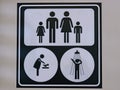 Public restroom signs for men, women, children, family, diaper changing station available in public area