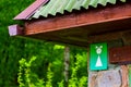 Public Restroom. White Female symbol on green background on Toilet Sign