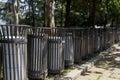 Public rubbish bins standing in a row in the park