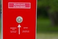 Public safety intercom box in red with emergency button and arrow Royalty Free Stock Photo