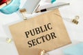 Public Sector text written on a craft envelope with office tools Royalty Free Stock Photo