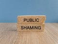 Public shaming symbol. Concept words Public shaming on brick blocks on a beautiful light blue background