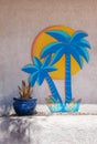 Sidewalk planter, Yucca plant and a painted Palm Tree Royalty Free Stock Photo