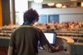 Public speaker giving talk at scientific conference.