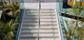 Public staircase stairway and chrome metal handrail divider with safety glass side sections