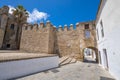 public street of Vejer de la Frontera village with ancient Segur Gate next to church