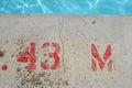 Public swimming pool, at pool`s edge showing lettering