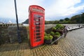 Public telephone box on harbour quay