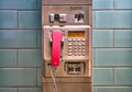 Public telephone made of silver metal with pink telephone receiver Royalty Free Stock Photo