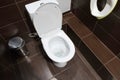 In the public toilet brown tile, white toilet bowl top view Royalty Free Stock Photo