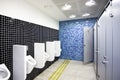 Public toilet with cubicles and urinals Royalty Free Stock Photo
