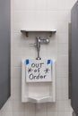 Public toilet men restroom. Male bathroom and broken toilet bowl in male toilet with sign out of order Royalty Free Stock Photo