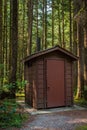 Public toilet in park. Summer day Wooden restroom or toilet building in remote forest in park. Bathrooms or WC Royalty Free Stock Photo