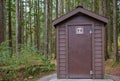 Public toilet in park. Summer day Wooden restroom or toilet building in remote forest in park. Bathrooms or WC