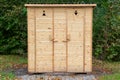 Public toilet in park. Wooden WC building in forest. Royalty Free Stock Photo