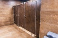 Public toilet restroom with brown doors in a row Royalty Free Stock Photo