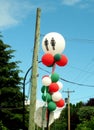 Public toilet sign on street party balloon garland. Royalty Free Stock Photo