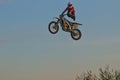 Public training in a public park. A brave biker jumps very high on a motorcycle and performs a stunt.