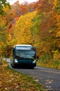 Public Transport Bus on Curved Road with Colorful Fall Foliage Royalty Free Stock Photo