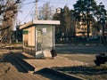 Public transport stop in the city (bus stop), cold autumn morning, the sun is shining