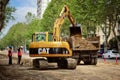 Public utility workers are replacing the water supply and sewerage system in the city. Working excavator on the roadway street Royalty Free Stock Photo