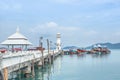 public white lighthouse on pier of Bang Bao fishing village with fishing boats mooring at Koh Chang Island,Trat, Thailand