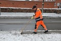 Publice woker remvoing snow from bus stop in Kastrup
