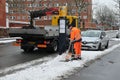 Publice woker remvoing snow from bus stop in Kastrup