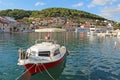 Pucisca, Brac Island, Croatia. Traditional fishing boat in the port. View of the city Royalty Free Stock Photo