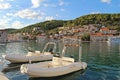 Pucisca, Brac Island, Croatia. Traditional fishing boat in the port. View of the city Royalty Free Stock Photo