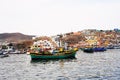 Pucusana, Peru -: views of peruvian fishermen boats and houses in Pucusana village in a cloudy morning in tourist Royalty Free Stock Photo