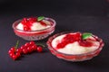 Pudding from semolina in a glass bowl with red currant syrup and berries. On a dark background Royalty Free Stock Photo