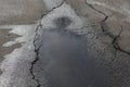 Puddle on asphalt alike a human figure with halo.