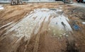 Puddle and mud with truck wheel track at construction site in rainy day Royalty Free Stock Photo