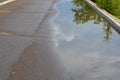 Puddle after rain on the road Royalty Free Stock Photo