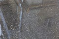 Puddle reflections of walls, windows, roofs of buildings on wet asphalt pavement of city street road after summer rain. Moscow,