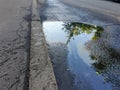 A puddle of spilled gasoline or oil product on the road. Environmental pollution concept Royalty Free Stock Photo
