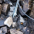 Puddle of used oil after removal of concrete pavement on a former gas station, contamination of soil, groundwater and environment