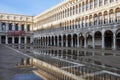 Puddle which reflects Procuratie Vecchie in Piazza San Marco in Venice