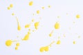 The puddles of an bright yellow oil paint spill. Watercolor yellow drop splash. Splatter of ink drops on white paper background. Royalty Free Stock Photo