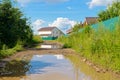 Puddles on a dirt road in a village Royalty Free Stock Photo