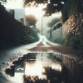 Puddles fill an empty country lane, as rain creates ripples in the water