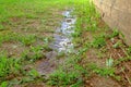 Puddles after rain near the wall of a wooden house Royalty Free Stock Photo