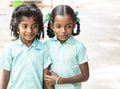 Best children friends girls classmates smiling standing with hand on arms at the school. Multiethnic school kids enjoying