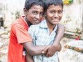 Unidentified best children boys friends smiling standing with hand on shoulder enjoying friendship