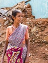 The portrait of an Asian woman in native dress looking on the side, in poor village