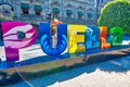 Puebla, Mexico-18 April, 2018: Puebla streets in historic city center, big letters displaying a city name at a central Zocalo